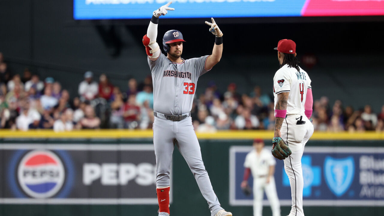 PHOENIX, ARIZONA - MAY 31: Nathaniel Lowe #33 of the Washington Nationals reacts after hitting an RBI double during the first inning against the Arizona Diamondbacks at Chase Field on May 31, 2025 in Phoenix, Arizona.
