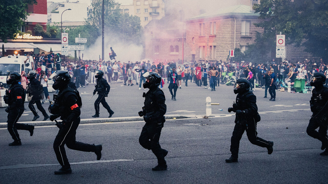 Police officers from the BRAV M motorized violent action repression squad in front of the crowd during celebrations on the Place de la Porte de Saint Cloud near the Parc des Princes stadium in Paris France on May 31, 2025, during the Paris Saint Germain PSG victory match in the UEFA Champions League final between Paris Saint Germain PSG and Inter Milan held in Munich on May 31, 2025.