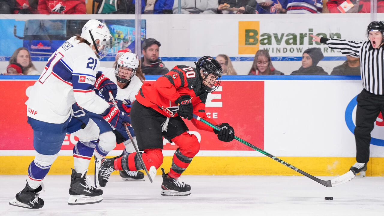 KITCHENER, CANADA - DECEMBER 14: Sarah Nurse #20 of Team Canada skates with the puck past Hilary Knight #21 and Caroline Harvey #4 of Team USA during the third period at Kitchener Memorial Auditorium on December 14, 2023 in Kitchener, Ontario, Canada.