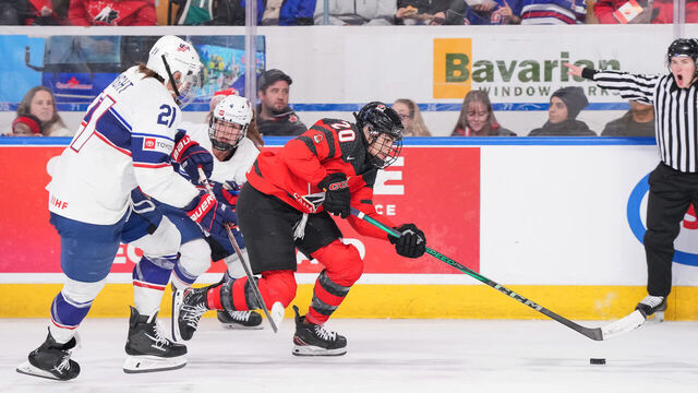 KITCHENER, CANADA - DECEMBER 14: Sarah Nurse #20 of Team Canada skates with the puck past Hilary Knight #21 and Caroline Harvey #4 of Team USA during the third period at Kitchener Memorial Auditorium on December 14, 2023 in Kitchener, Ontario, Canada.