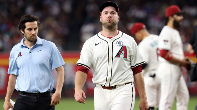 PHOENIX, ARIZONA - JUNE 01: Starting pitcher Corbin Burnes #39 of the Arizona Diamondbacks walks off the field with assistant athletic trainer Max Esposito during the fifth inning against the Washington Nationals at Chase Field on June 01, 2025 in Phoenix, Arizona. The Diamondbacks defeated the Nationals 3-1.