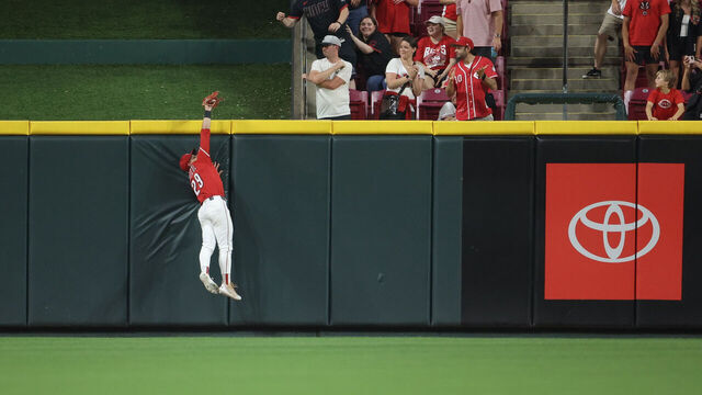 CINCINNATI, OH - JUNE 03: TJ Friedl #29 of the Cincinnati Reds catches a fly ball at the outfield wall to rob a potential game-tying home run in the ninth inning during the game between the Milwaukee Brewers and the Cincinnati Reds at Great American Ball Park on Tuesday, June 3, 2025 in Cincinnati, Ohio.