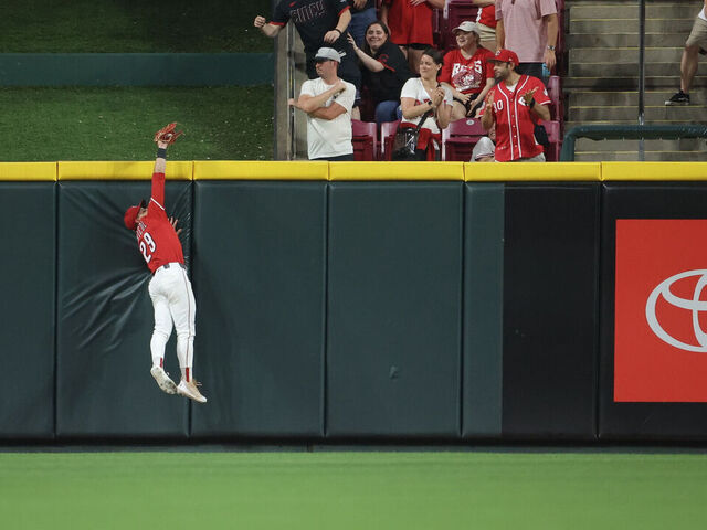 CINCINNATI, OH - JUNE 03: TJ Friedl #29 of the Cincinnati Reds catches a fly ball at the outfield wall to rob a potential game-tying home run in the ninth inning during the game between the Milwaukee Brewers and the Cincinnati Reds at Great American Ball Park on Tuesday, June 3, 2025 in Cincinnati, Ohio.