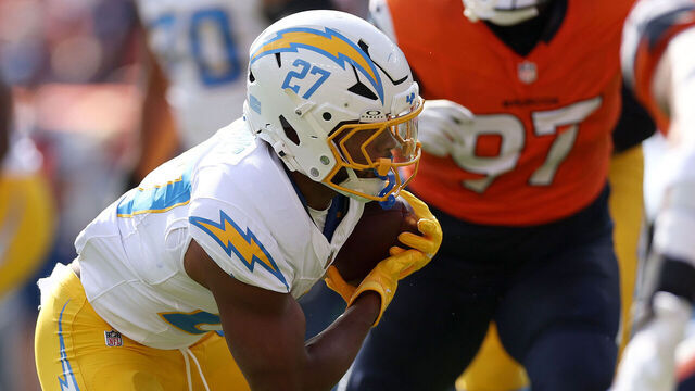 DENVER, COLORADO - OCTOBER 13: J.K. Dobbins # of the Los Angeles Chargers carries the ball against the Denver Broncos in the first quarter at Empower Field At Mile High on October 13, 2024 in Denver, Colorado.