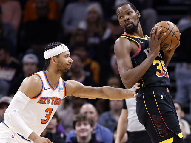 PHOENIX, ARIZONA - DECEMBER 15: Kevin Durant #35 of the Phoenix Suns posts up on Josh Hart #3 of the New York Knicks during the game at Footprint Center on December 15, 2023 in Phoenix, Arizona. The Knicks defeated the Suns 139-122.