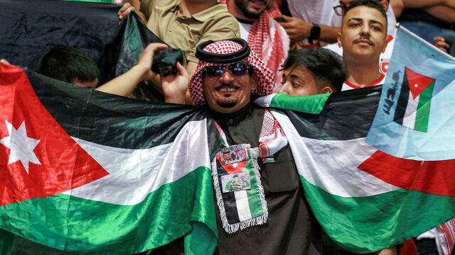 Jordan's fans cheer as they watch the 2026 FIFA World Cup Asian Qualifier football match between Jordan and Oman on big screens at the Prince Hamza hall in the Sports City in Amman on June 5, 2025.
