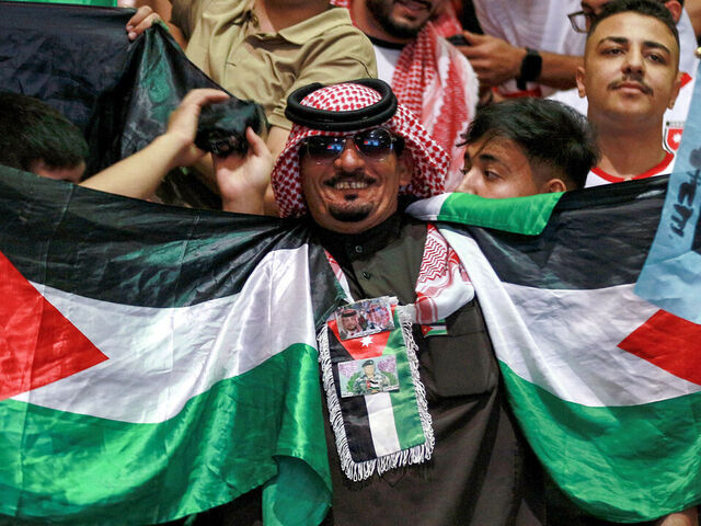 Jordan's fans cheer as they watch the 2026 FIFA World Cup Asian Qualifier football match between Jordan and Oman on big screens at the Prince Hamza hall in the Sports City in Amman on June 5, 2025.