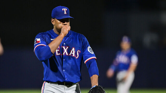TAMPA, FLORIDA - JUNE 04: Pitcher Kumar Rocker #80 of the Texas Rangers blows on his hand in the third inning against the Tampa Bay Rays at George M. Steinbrenner Field on June 04, 2025 in Tampa, Florida.