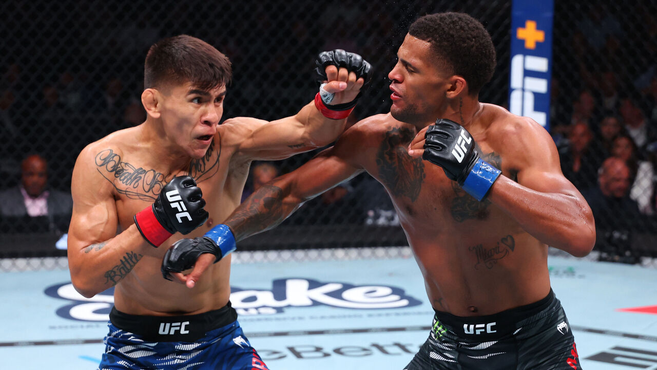 NEWARK, NEW JERSEY - JUNE 07: (L-R) Mario Bautista punches Patchy Mix in a bantamweight bout during the UFC 316 event at Prudential Center on June 07, 2025 in Newark, New Jersey.