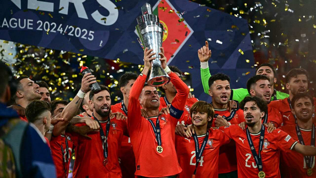 Portugal's players including Portugal's forward #07 Cristiano Ronaldo celebrate with the trophy after winning the UEFA Nations League final football match between Portugal and Spain in Munich, southern Germany on June 8, 2025.