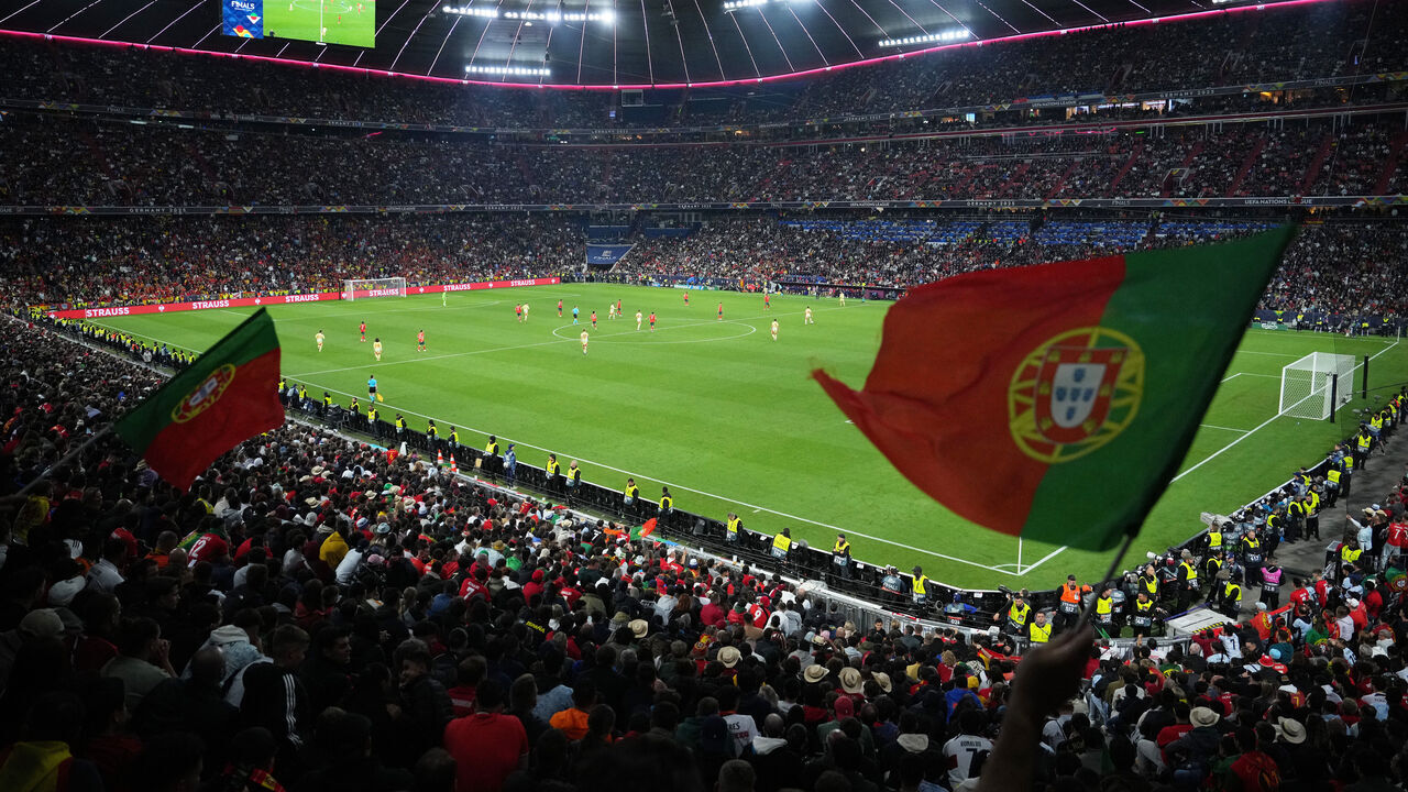 MUNICH, GERMANY - JUNE 08: General view inside the stadium as Portugal fans wave flags during the UEFA Nations League 2025 final match between Portugal and Spain at Munich Football Arena on June 08, 2025 in Munich, Germany.