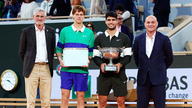 PARIS, FRANCE - JUNE 08: Carlos Alcaraz of Spain poses for a photo with the Coupe des Mousquetaires trophy alongside runner-up Jannik Sinner of Italy, Gilles Moretton, President of the FFT and Andre Agassi, former French Open champion, following his victory in the Men’s Singles Final match on Day Fifteen of the 2025 French Open at Roland Garros on June 08, 2025 in Paris, France.