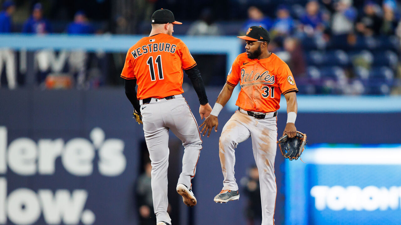 TORONTO, CANADA - MARCH 29: Jordan Westburg #11 and Cedric Mullins #31 of the Baltimore Orioles celebrate at in the outfiedl at the end of their MLB game against the Toronto Blue Jays at Rogers Centre on March 29, 2025 in Toronto, Ontario, Canada.