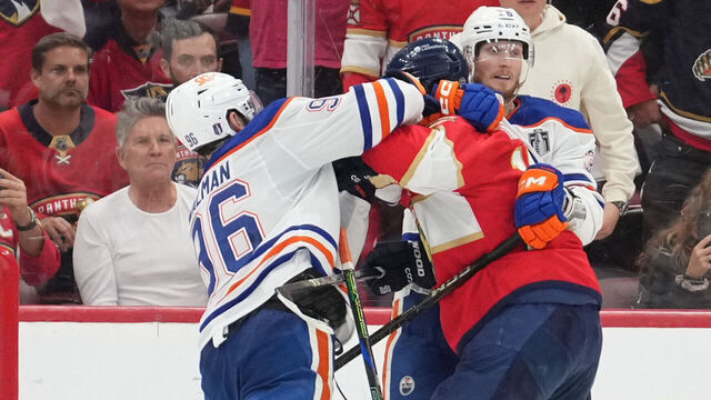 SUNRISE, FL - JUNE 09: while being held by an Edmonton players, Edmonton Oilers defenseman Jake Walman (96) punches Florida Panthers left wing Matthew Tkachuk (19) in the face in the third period during game three of the Stanley Cup Finals between the Edmonton Oilers and the Florida Panthers on June 9, 2025 at Amerant Bank Arena, FL.
