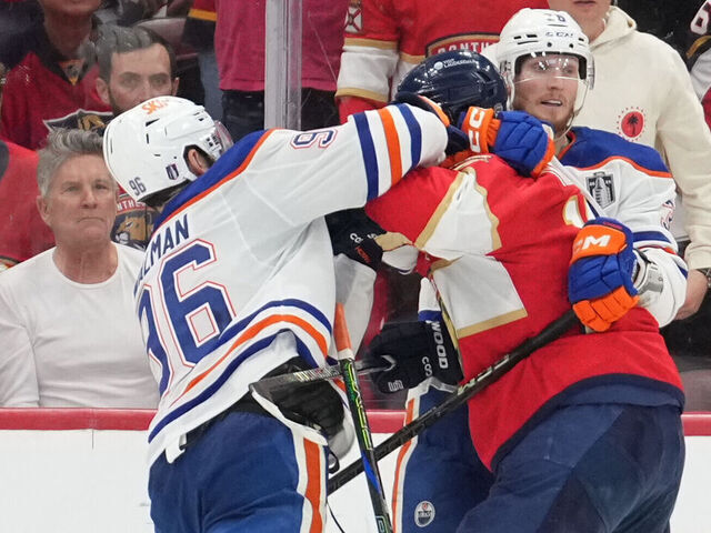 SUNRISE, FL - JUNE 09: while being held by an Edmonton players, Edmonton Oilers defenseman Jake Walman (96) punches Florida Panthers left wing Matthew Tkachuk (19) in the face in the third period during game three of the Stanley Cup Finals between the Edmonton Oilers and the Florida Panthers on June 9, 2025 at Amerant Bank Arena, FL.