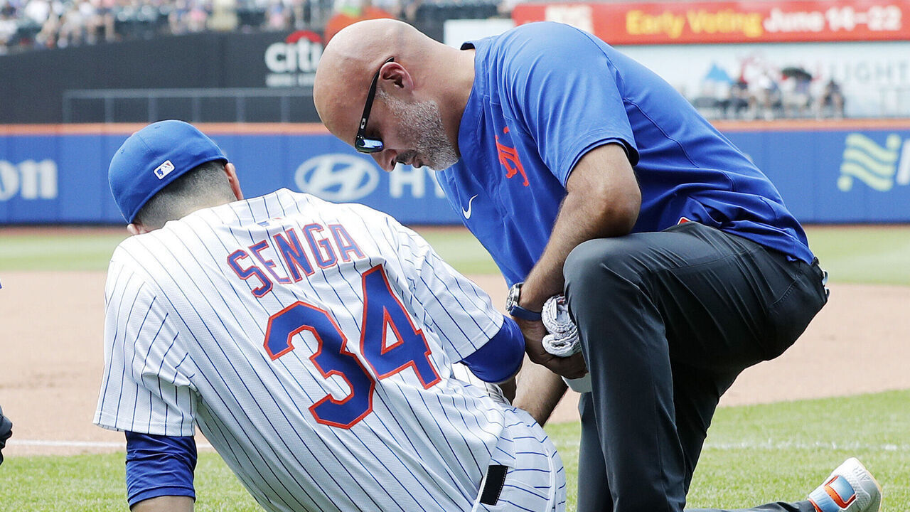 NEW YORK, NEW YORK - JUNE 12: Kodai Senga #34 of the New York Mets is tended too on the field after an injury during the sixth inning against the Washington Nationals at Citi Field on June 12, 2025 in New York City.