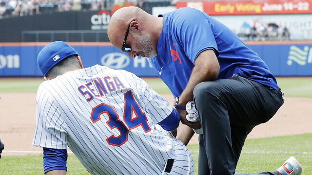 NEW YORK, NEW YORK - JUNE 12: Kodai Senga #34 of the New York Mets is tended too on the field after an injury during the sixth inning against the Washington Nationals at Citi Field on June 12, 2025 in New York City.