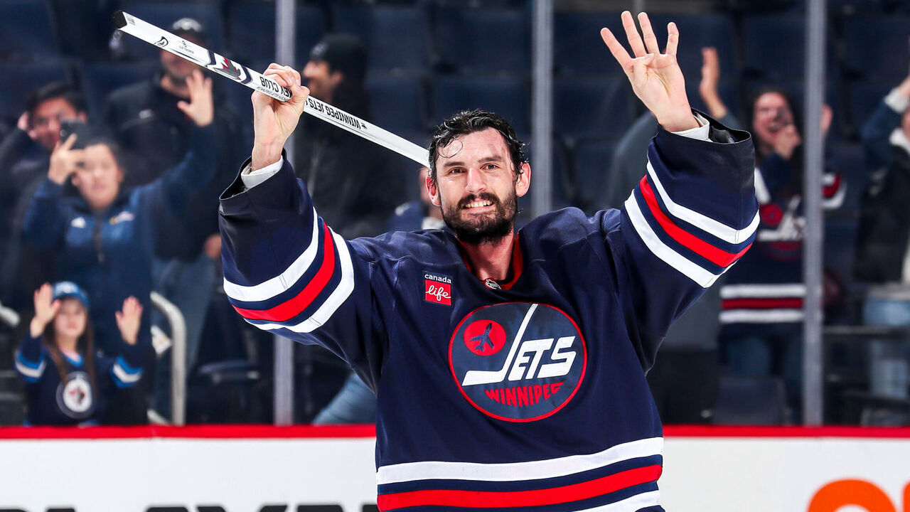 WINNIPEG, CANADA - NOVEMBER 7: Goaltender Connor Hellebuyck #37 of the Winnipeg Jets is all smiles as he salutes the fans after receiving first star honours following a 1-0 shutout victory over the Colorado Avalanche at the Canada Life Centre on November 7, 2024 in Winnipeg, Manitoba, Canada. This shutout marks the 40th of Hellebuyck's career.