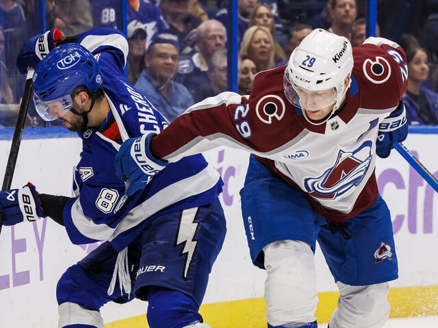 TAMPA, FL - NOVEMBER 25: Nikita Kucherov #86 of the Tampa Bay Lightning battles against Nathan MacKinnon #29 of the Colorado Avalanche at Amalie Arena on November 25, 2024 in Tampa, Florida.