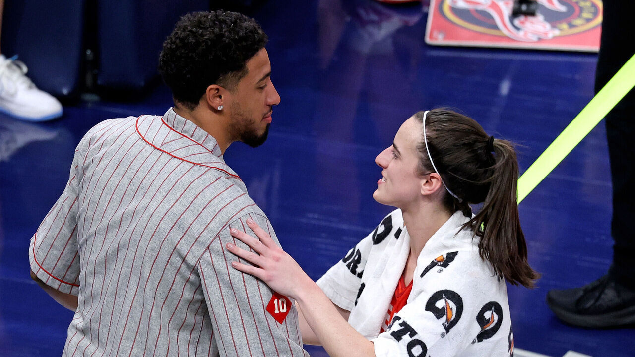 INDIANAPOLIS, IN - AUGUST 16: Indiana Fever guard Caitlin Clark (22) talks to Indiana Pacer guard Tyrese Haliburton after defeating the Phoenix Mercury at Gainbridge Fieldhouse on August 16, 2024 in Indianapolis, Indiana.