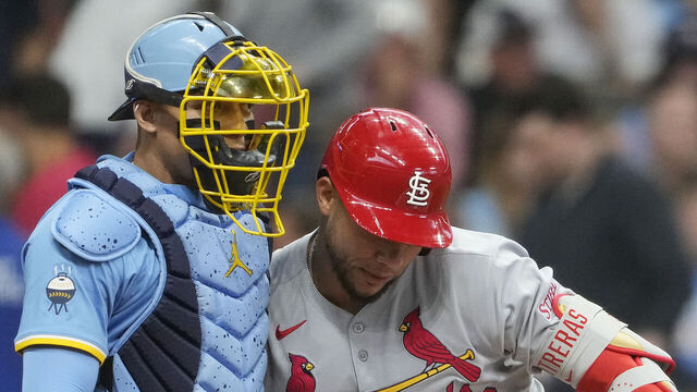 MILWAUKEE, WISCONSIN - JUNE 12: William Contreras #24 of the Milwaukee Brewers and Willson Contreras #40 of the St. Louis Cardinals hug during the second inning at American Family Field on June 12, 2025 in Milwaukee, Wisconsin.