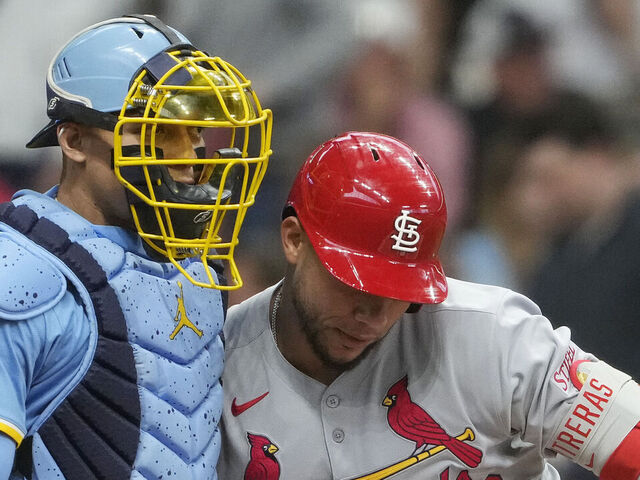 MILWAUKEE, WISCONSIN - JUNE 12: William Contreras #24 of the Milwaukee Brewers and Willson Contreras #40 of the St. Louis Cardinals hug during the second inning at American Family Field on June 12, 2025 in Milwaukee, Wisconsin.