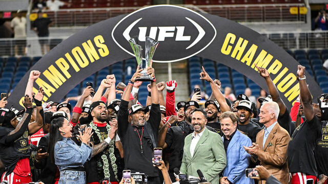 ST. LOUIS, MO - JUNE 14: DC Defenders Head Coach Shannon Harris lifts the championship trophy for his team during the UFL Championship game with the Michigan Panthers versus the DC Defenders on Saturday June 14, 2025, at The Dome at America's Center in St. Louis MO