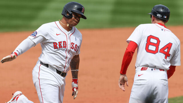 BOSTON, MA - JUNE 15: Rafael Devers #11 of the Boston Red Sox celebrates with third-base coach Kyle Hudson #84 after hitting a solo home run in the fifth inning during the game between the New York Yankees and the Boston Red Sox at Fenway Park on Sunday, June 15, 2025 in Boston, Massachusetts.