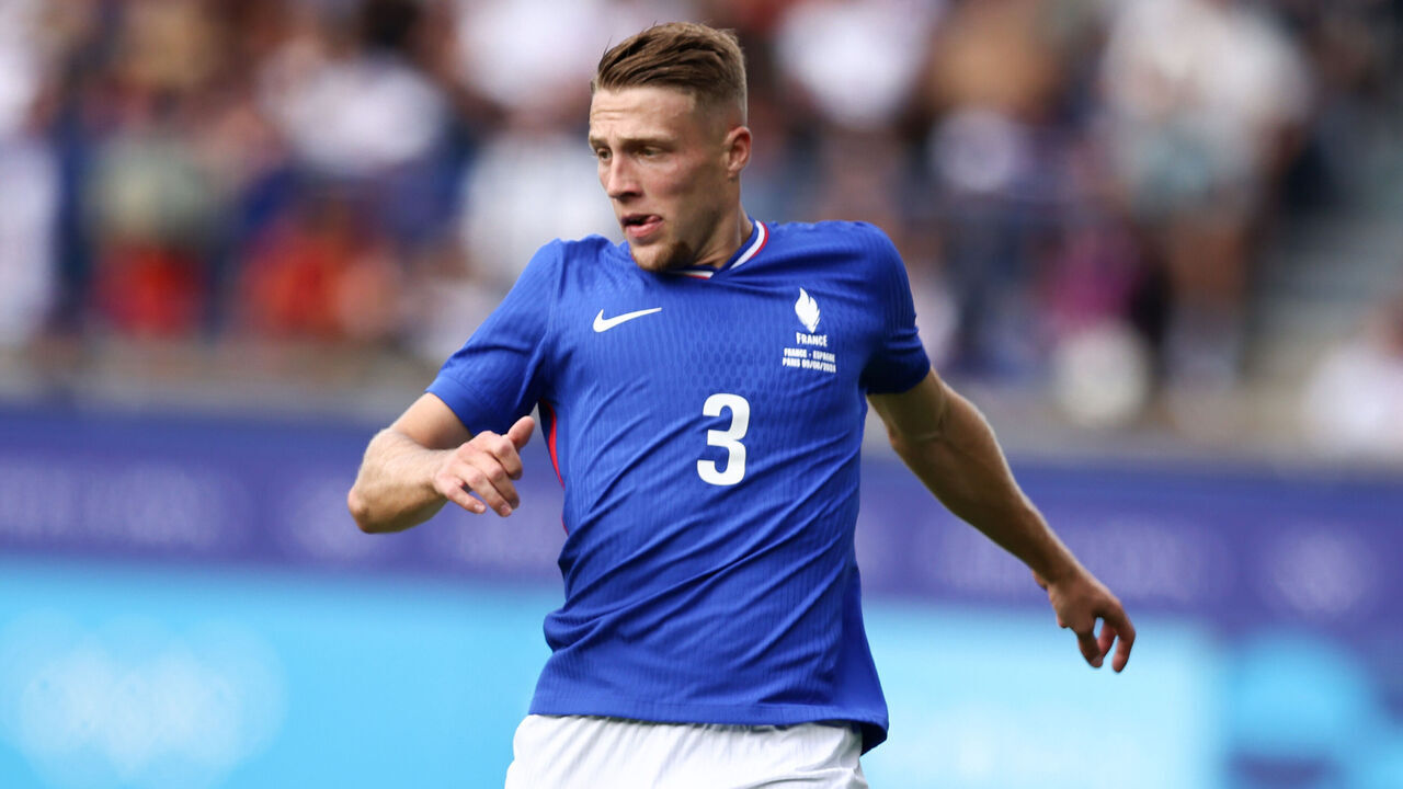 PARIS, FRANCE - AUGUST 09: Adrien Truffert of Team France runs with a ball during the Men's Gold Medal match between France and Spain during the Olympic Games Paris 2024 at Parc des Princes on August 09, 2024 in Paris, France.