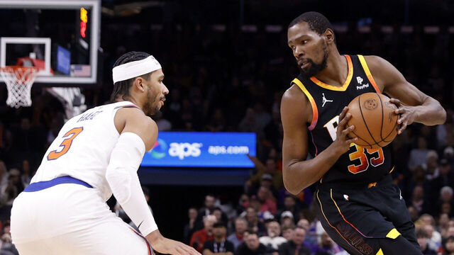 PHOENIX, ARIZONA - DECEMBER 15: Kevin Durant #35 of the Phoenix Suns posts up on Josh Hart #3 of the New York Knicks during the game at Footprint Center on December 15, 2023 in Phoenix, Arizona. The Knicks defeated the Suns 139-122.
