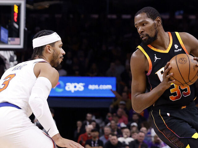 PHOENIX, ARIZONA - DECEMBER 15: Kevin Durant #35 of the Phoenix Suns posts up on Josh Hart #3 of the New York Knicks during the game at Footprint Center on December 15, 2023 in Phoenix, Arizona. The Knicks defeated the Suns 139-122.
