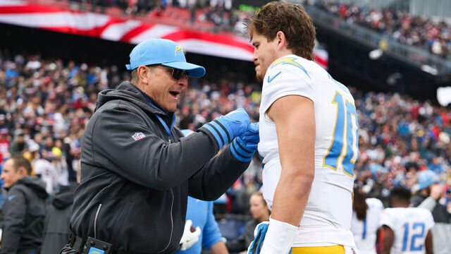 FOXBOROUGH, MASSACHUSETTS - DECEMBER 28: Jim Harbaugh head coach of the Los Angeles Chargers pumps up Justin Herbert #10 of the Los Angeles Chargers prior to the start of the game against the New England Patriots at Gillette Stadium on December 28, 2024 in Foxborough, Massachusetts.