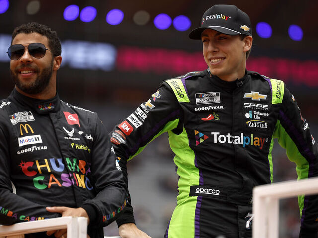 MEXICO CITY, MEXICO - JUNE 15: Bubba Wallace, driver of the #23 Chumba Casino Toyota, (L) and Carson Hocevar, driver of the #77 Totalplay Chevrolet, look on during pre-race ceremonies prior to the NASCAR Cup Series Viva Mexico 250 at Autodromo Hermanos Rodriguez on June 15, 2025 in Mexico City, Mexico.
