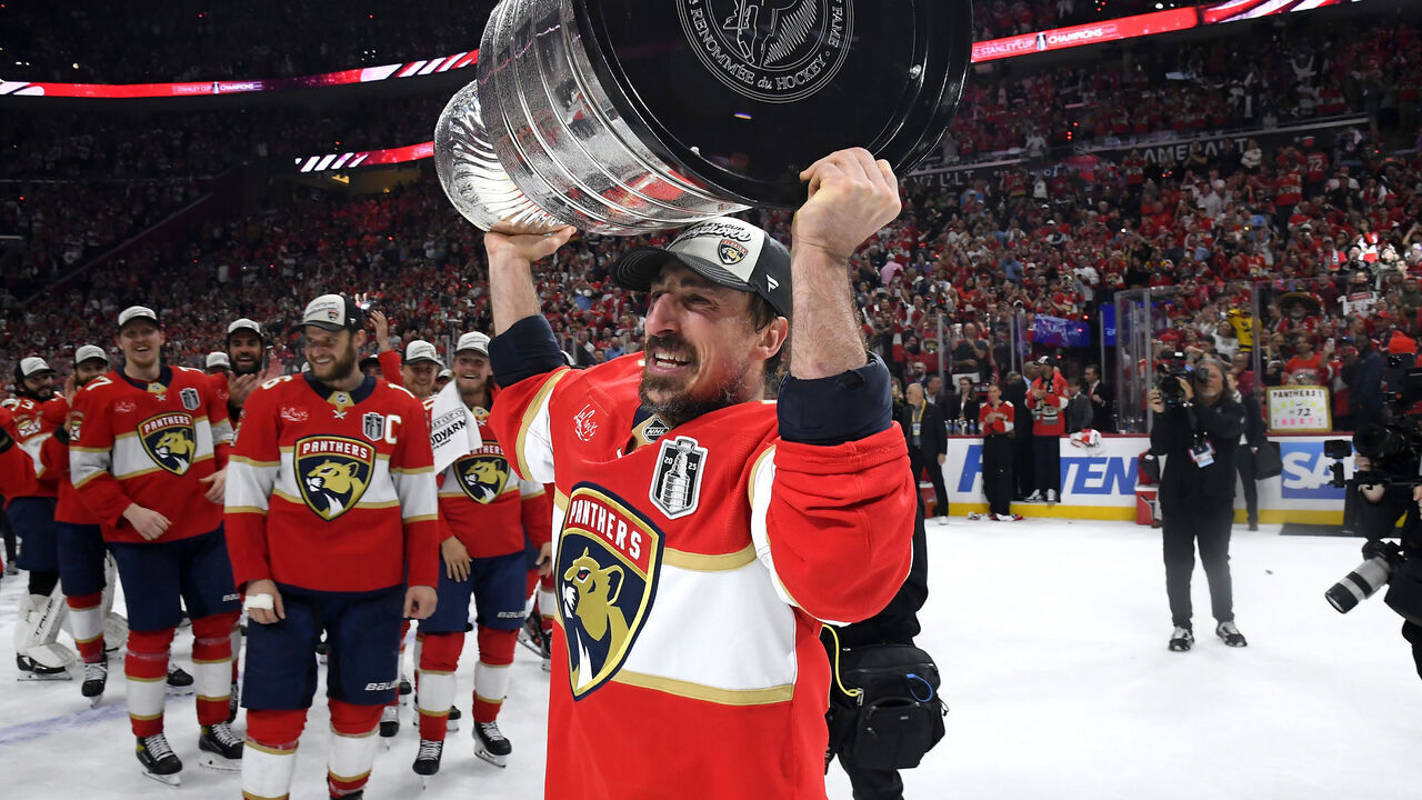 SUNRISE, FLORIDA - JUNE 17: Brad Marchand #63 of the Florida Panthers hoists the Stanley Cup after Game Six of the 2025 Stanley Cup Final between the Edmonton Oilers and the Florida Panthers at Amerant Bank Arena on June 17, 2025 in Sunrise, Florida. The Panthers won the Stanley Cup Final series 4-2.