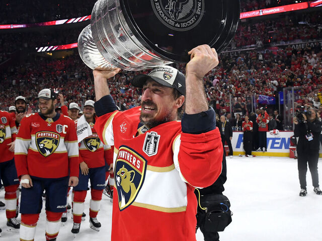 SUNRISE, FLORIDA - JUNE 17: Brad Marchand #63 of the Florida Panthers hoists the Stanley Cup after Game Six of the 2025 Stanley Cup Final between the Edmonton Oilers and the Florida Panthers at Amerant Bank Arena on June 17, 2025 in Sunrise, Florida. The Panthers won the Stanley Cup Final series 4-2.