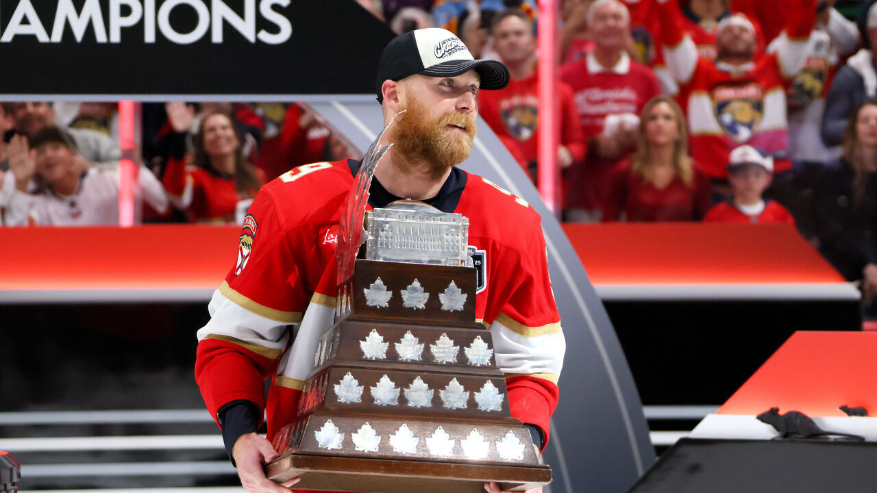 SUNRISE, FLORIDA - JUNE 17: Sam Bennett #9 of the Florida Panthers celebrates with the Conn Smythe Trophy after defeating the Edmonton Oilers in Game Six of the 2025 Stanley Cup Final at Amerant Bank Arena on June 17, 2025 in Sunrise, Florida.