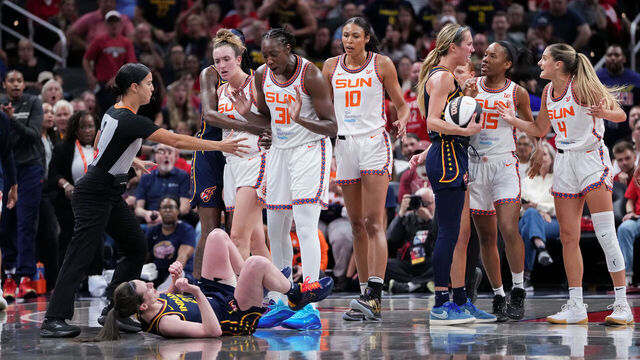 INDIANAPOLIS, INDIANA - JUNE 17: Caitlin Clark #22 of the Indiana Fever falls to the floor after being pushed by Marina Mabrey #3 of the Connecticut Sun during an altercation in the third quarter at Gainbridge Fieldhouse on June 17, 2025 in Indianapolis, Indiana.