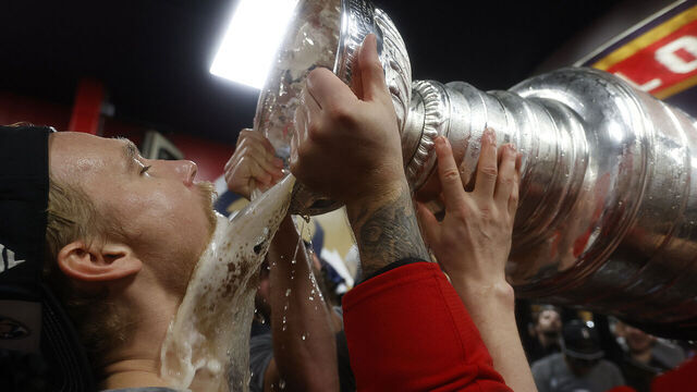 SUNRISE, FLORIDA - JUNE17: Gustav Forsling #42 of the Florida Panthers drinks from the Stanley Cup in the locker room during their team celebration after beating the Edmonton Oilers in Game Six of the 2025 Stanley Cup Final at the Amerant Bank Arena on June 17, 2025 in Sunrise, Florida.