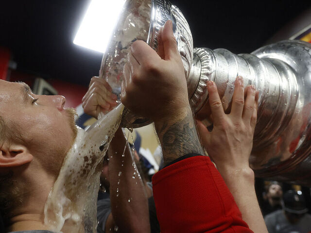 SUNRISE, FLORIDA - JUNE17: Gustav Forsling #42 of the Florida Panthers drinks from the Stanley Cup in the locker room during their team celebration after beating the Edmonton Oilers in Game Six of the 2025 Stanley Cup Final at the Amerant Bank Arena on June 17, 2025 in Sunrise, Florida.