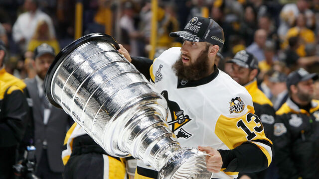 NASHVILLE, TN - JUNE 11: Nick Bonino #13 of the Pittsburgh Penguins celebrates with the Stanley Cup trophy after they defeated the Nashville Predators 2-0 in Game Six of the 2017 NHL Stanley Cup Final at the Bridgestone Arena on June 11, 2017 in Nashville, Tennessee.