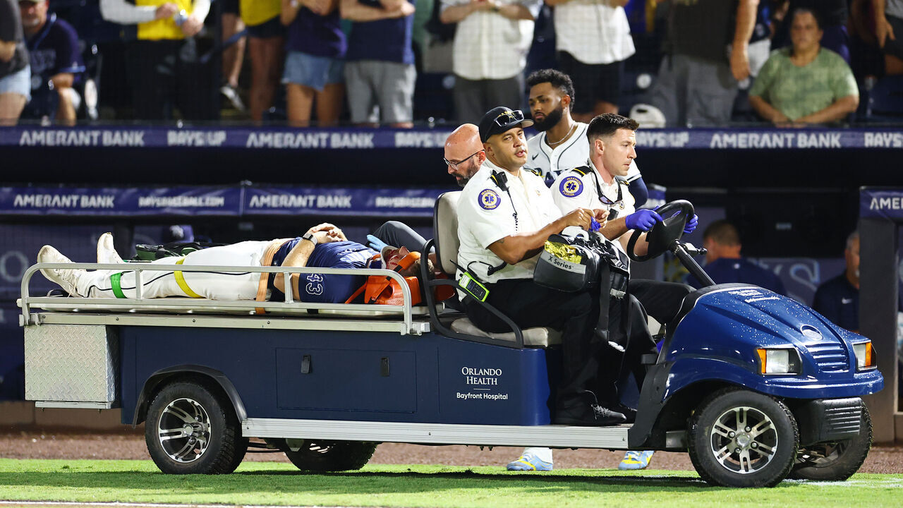 TAMPA, FLORIDA - JUNE 19: Junior Caminero #13 looks on as Hunter Bigge #43 of the Tampa Bay Rays is carted off after getting hit by a foul ball off the bat of Adley Rutschman of the Baltimore Orioles (not pictured) in the seventh inning at George M. Steinbrenner Field on June 19, 2025 in Tampa, Florida.