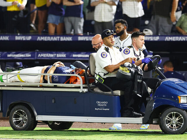 TAMPA, FLORIDA - JUNE 19: Junior Caminero #13 looks on as Hunter Bigge #43 of the Tampa Bay Rays is carted off after getting hit by a foul ball off the bat of Adley Rutschman of the Baltimore Orioles (not pictured) in the seventh inning at George M. Steinbrenner Field on June 19, 2025 in Tampa, Florida.
