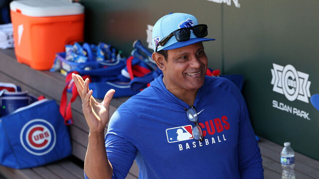 MESA, ARIZONA - FEBRUARY 27: Former MLB player Sammy Sosa talks with Chicago Cubs players in the dugout before a spring training game against the Los Angeles Angels at Sloan Park on February 27, 2025 in Mesa, Arizona.