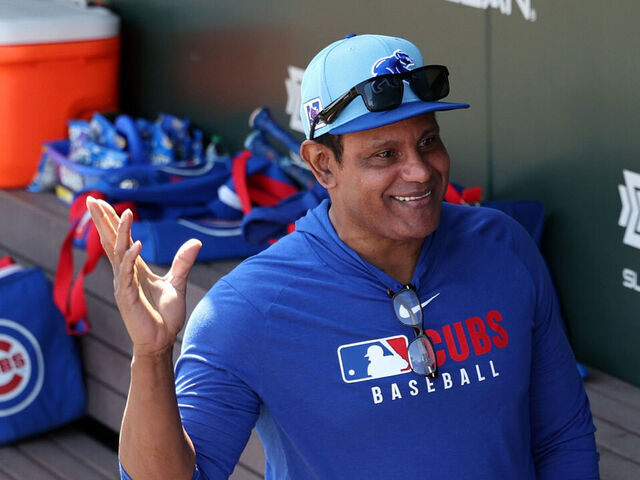 MESA, ARIZONA - FEBRUARY 27: Former MLB player Sammy Sosa talks with Chicago Cubs players in the dugout before a spring training game against the Los Angeles Angels at Sloan Park on February 27, 2025 in Mesa, Arizona.