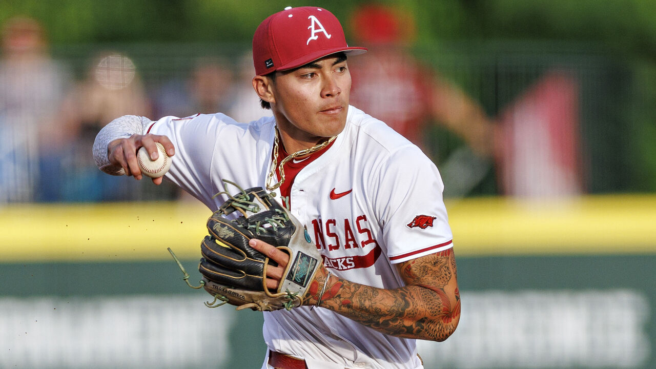FAYETTEVILLE, ARKANSAS - MAY 15: Wehiwa Aloy #9 of the Arkansas Razorbacks throws to first base during game one of the series against the Tennessee Volunteers at Baum-Walker Stadium at George Cole Field on May 15, 2025 in Fayetteville, Arkansas. The Volunteers defeated the Razorbacks 10-7.