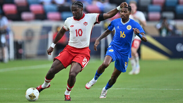 HOUSTON, TEXAS - JUNE 21: Jonathan David of Canada and Jearl Margaritha of Curacao battle for a ball during the Group Stage - Group B match between Curacao and Canada as part of the 2025 CONCACAF Gold Cup at the Shell Energy Stadium on June 21, 2025 in Houston, Texas.