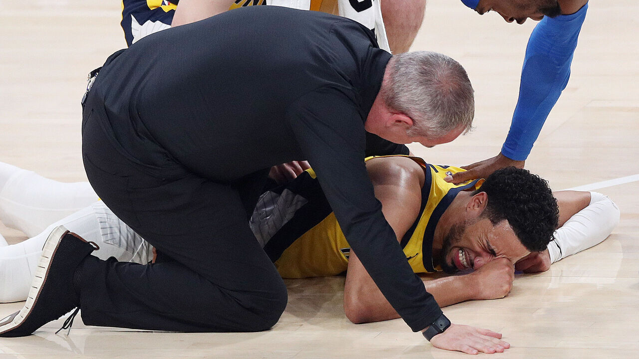 OKLAHOMA CITY, OKLAHOMA - JUNE 22: Tyrese Haliburton #0 of the Indiana Pacers sustains an injury during the first quarter as Shai Gilgeous-Alexander #2 of the Oklahoma City Thunder checks on him in Game Seven of the 2025 NBA Finals at Paycom Center on June 22, 2025 in Oklahoma City, Oklahoma.