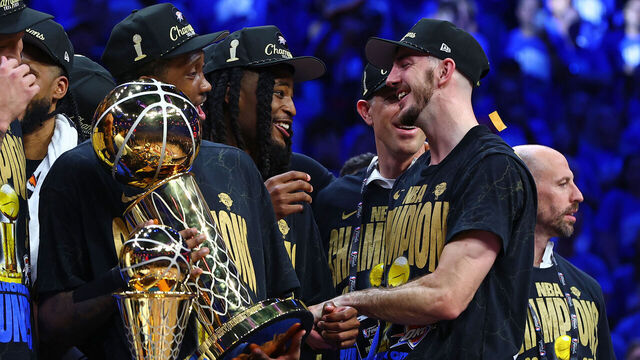 OKLAHOMA CITY, OK - JUNE 22: Alex Caruso of the Oklahoma City Thunder celebrates on stage with the Larry O'Brien Trophy after winning Game Seven of the 2025 NBA Finals against the Indiana Pacers on June 22, 2025 at Paycom Center in Oklahoma City, Oklahoma. Mandatory Copyright Notice: Copyright 2025 NBAE