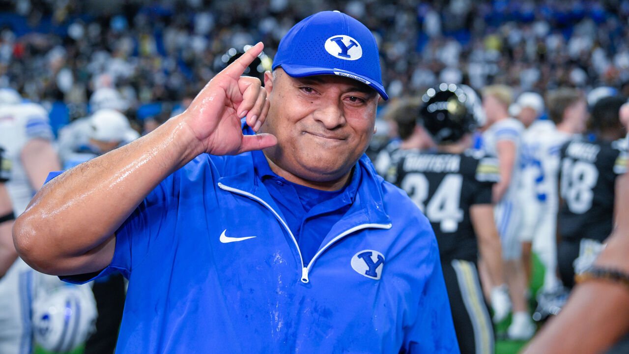 SAN ANTONIO, TX - DECEMBER 28: Brigham Young Cougars head coach Kalani Sitake is elated following his post game interview near midfield during the football game between the BYU Cougars and Colorado Buffaloes on December 28, 2024, at the Alamodome in San Antonio, Texas.