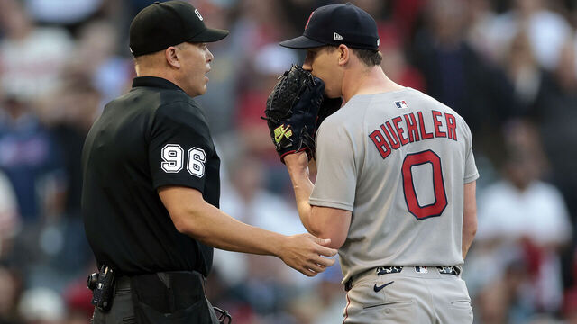 ANAHEIM, CALIFORNIA - JUNE 23: Umpire Chris Segal #96 talks with Walker Buehler #0 of the Boston Red Sox after Zach Neto #9 of the Los Angeles Angels was hit by a pitch in the first inning at Angel Stadium of Anaheim on June 23, 2025 in Anaheim, California.